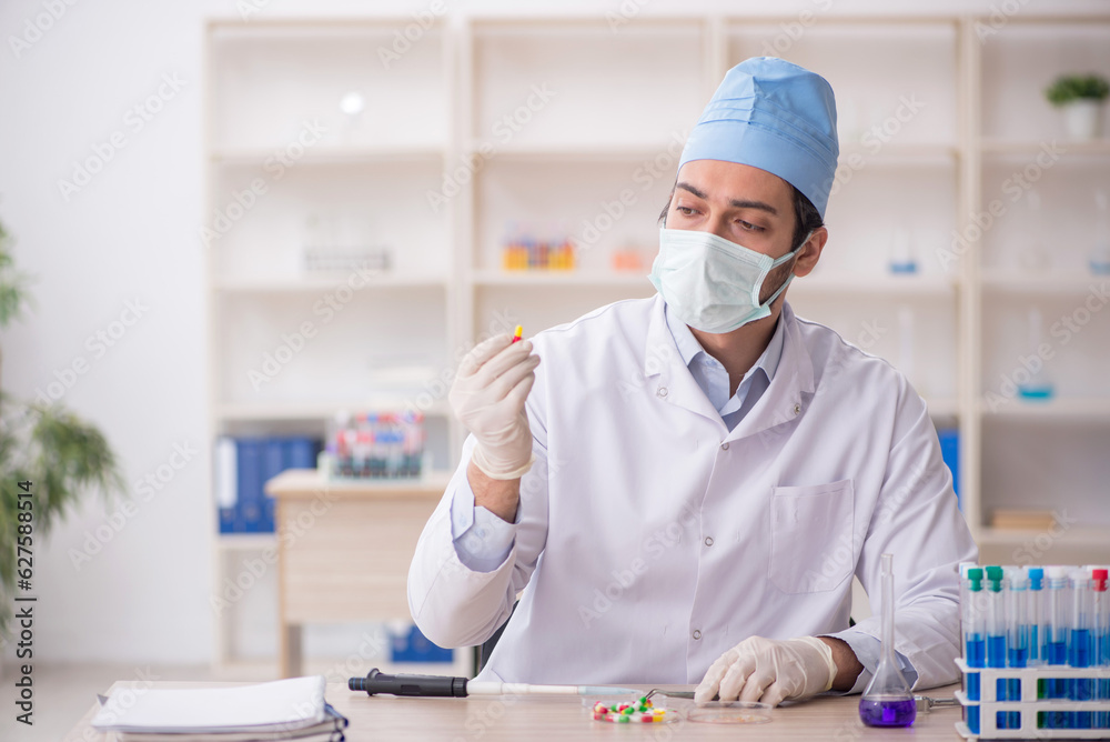 Young male chemist working at the lab Young male chemist working at the lab
