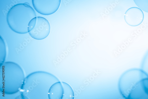 Abstract Fun Background, Beautiful Transparent Shiny Blue Soap Bubbles Floating in The Air. Blank White Space, Blue Gradient Blurred Background, Refreshing of Soap Suds Bubbles Water.