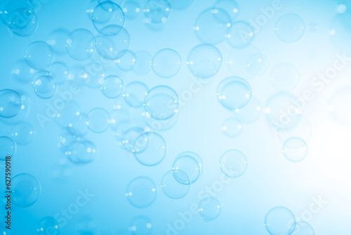 Beautiful Transparent Blue Soap Bubbles Floating in The Air. White Space  Abstract Fun Background  Blue Gradient Blurred Background  Refreshing of Soap Suds Bubbles Water.