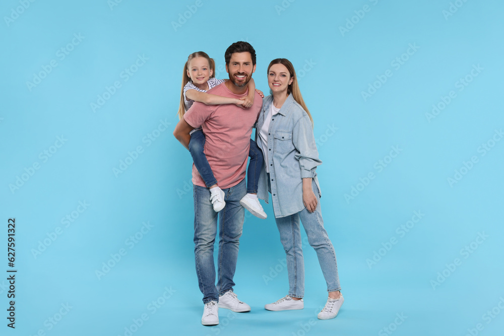 Happy family together on light blue background Happy family together on light blue background