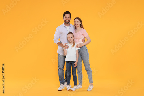 Portrait of happy family on orange background © New Africa