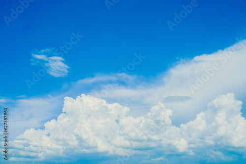 huge White fluffy cloud against blue sky summer abstract weather background. © Parichart