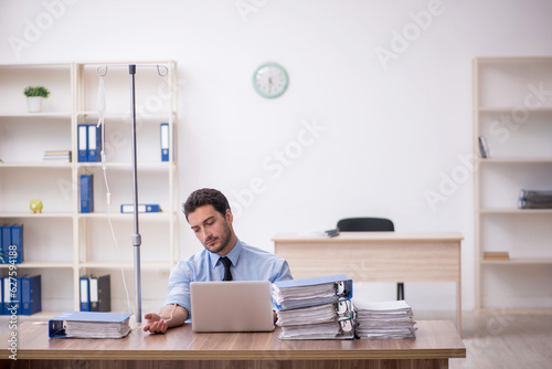 Young male employee suffering at workplace © Elnur