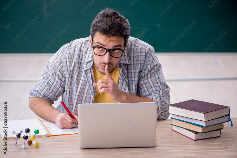 Young male student sitting in the classroom Young male student sitting in the classroom