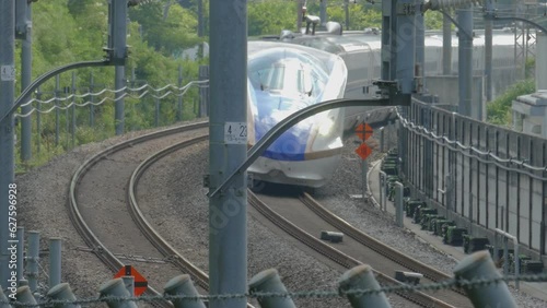 Hokuriku Shinkansen leaving Karuizawa Station on its way towards Tokyo on a hot summer day. Taken on July 22, 2023. photo