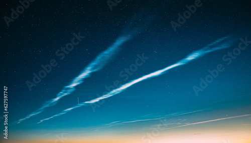 Fototapeta Naklejka Na Ścianę i Meble -  Night Starry Sky And Noctilucent Clouds Above Summer Meadow Landscape. Glowing Stars And Night Shining Clouds. Tenuous Cloud-like Phenomena In The Upper Atmosphere Of Earth.