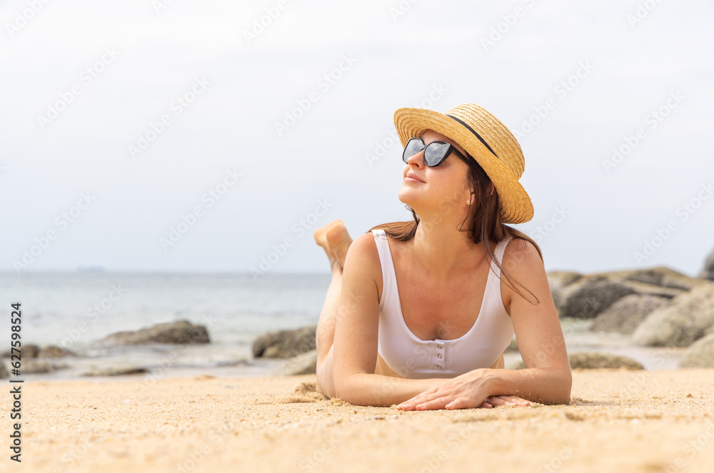 Woman lying on the sea beach