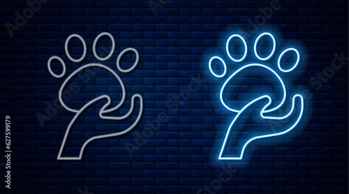 Glowing neon line Animal volunteer icon isolated on brick wall background. Animal care concept. Vector