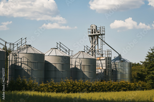 Agribusiness landscape. Steel Agricultural Silos - Building Exterior, Storage and drying of grains, wheat, corn, soy and sunflower