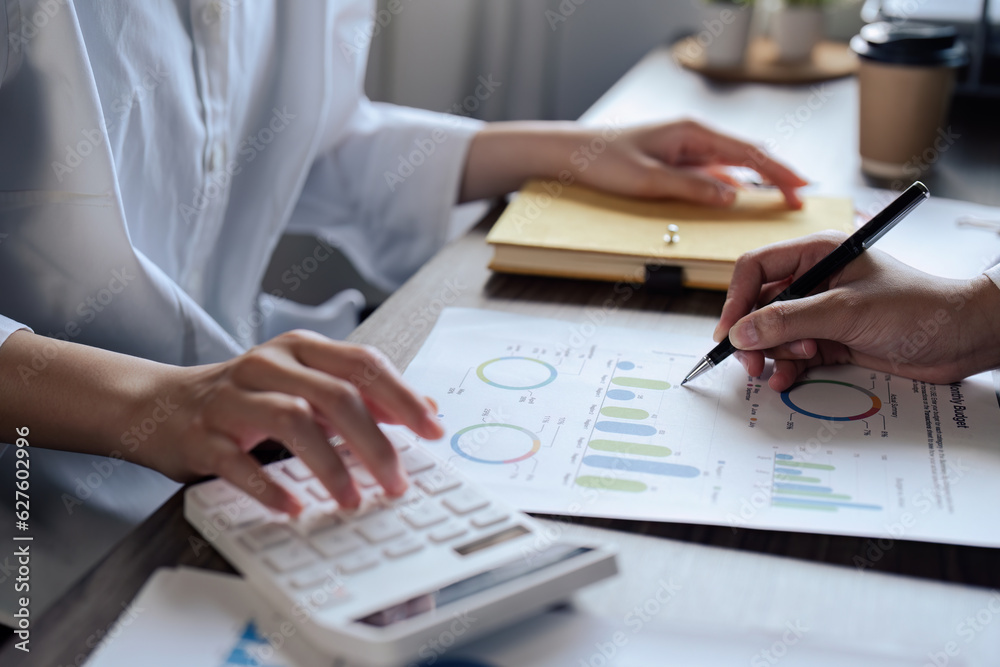 Teamwork of business people discuss and use calculator for finance paperwork data in office Teamwork of business people discuss and use calculator for finance paperwork data in office