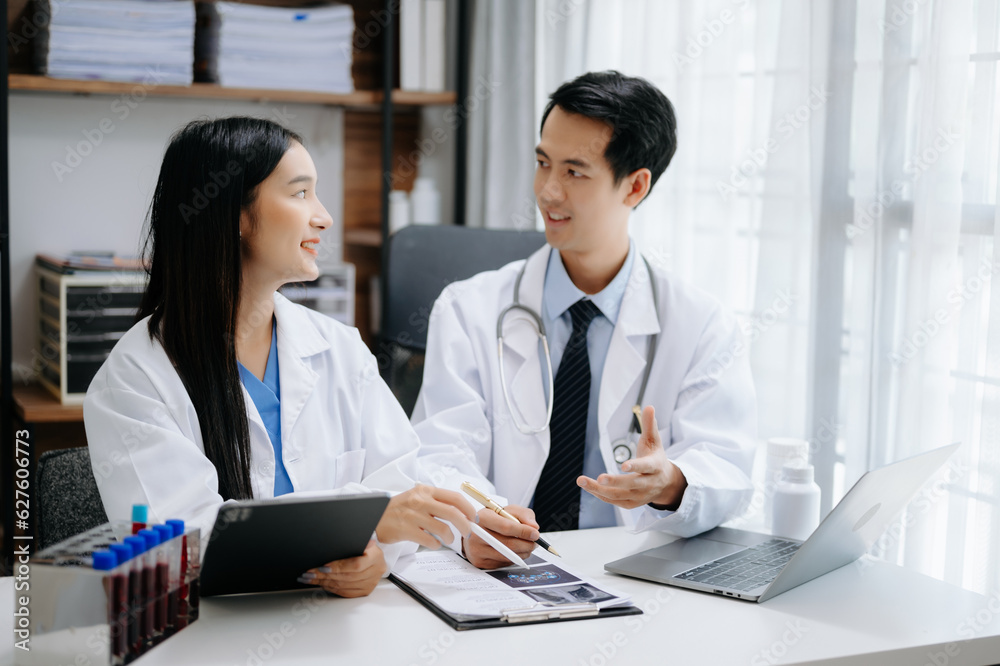 Medical technology network team meeting concept. Asian Doctor hand working with smart phone modern digital tablet and laptop computer with graphics chart interface, Medical technology network team meeting concept. Asian Doctor hand working with smart phone modern digital tablet and laptop computer with graphics chart interface,