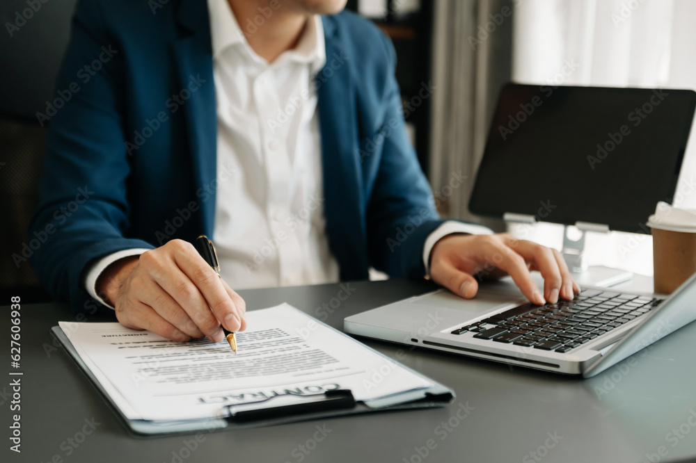 business documents on office table with smart phone and digital tablet and graph financial and woman working at office. business documents on office table with smart phone and digital tablet and graph financial and woman working at office.