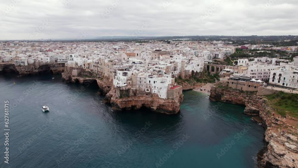 Aerial rotate view of Polignano travel destination town on rocky coast, Puglia, Italy Aerial rotate view of Polignano travel destination town on rocky coast, Puglia, Italy