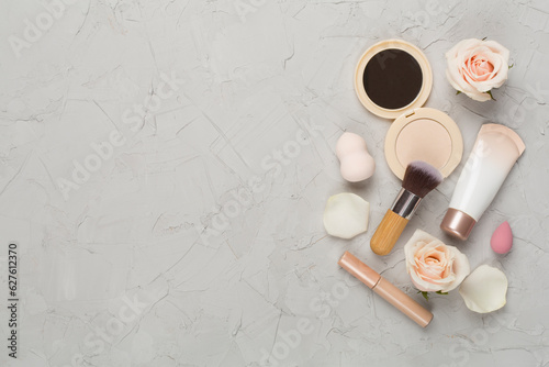 Composition with makeup products for skin tone on concrete background, top view