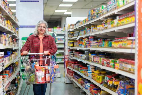 Wallpaper Mural senior indian woman purchasing at grocery shop. Torontodigital.ca