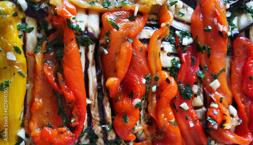 Peperoni colorati arrostiti fatti in casa con prezzemolo, aglio, aceto e olio d'oliva su sfondo bianco.  Cibo vegetariano. Vista dall'alto. photo