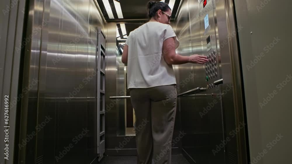 Efficient Commute: Businesswoman with Briefcase and Tablet Entering the Office Center Elevator, Initiating Smooth Vertical Transportation. High quality 4k footage Efficient Commute: Businesswoman with Briefcase and Tablet Entering the Office Center Elevator, Initiating Smooth Vertical Transportation. High quality 4k footage