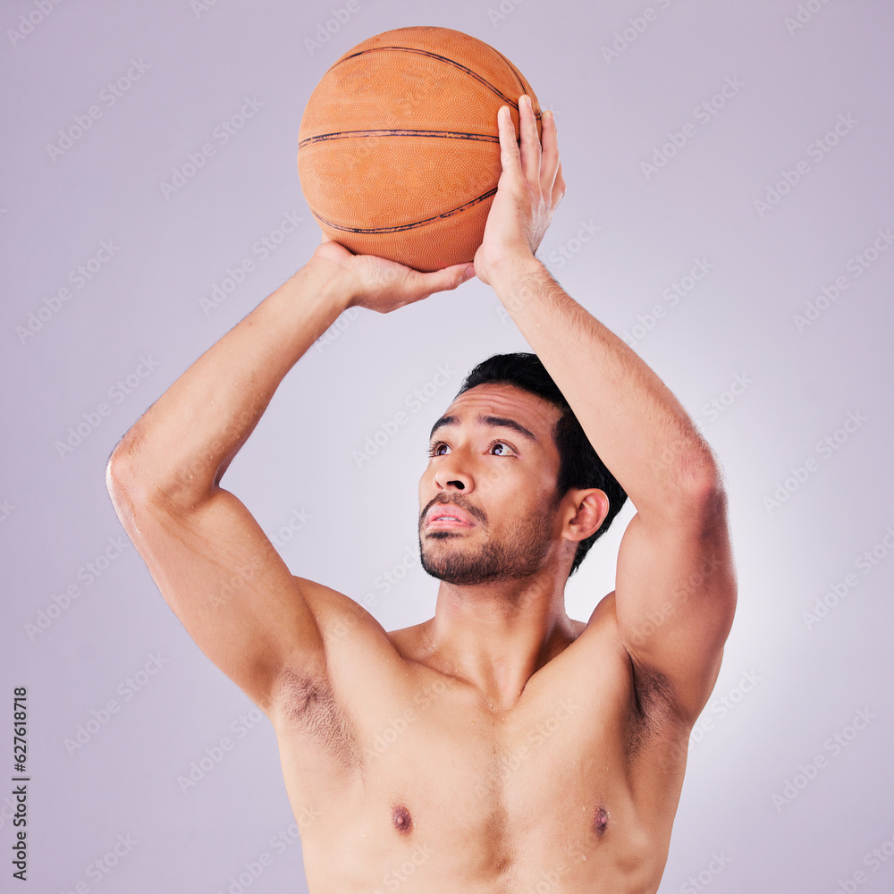 Fitness, basketball and a sports asian man shooting in studio on a gray background for training or a game. Exercise, body or aim and a shirtless young male athlete holding a ball during a competition Fitness, basketball and a sports asian man shooting in studio on a gray background for training or a game. Exercise, body or aim and a shirtless young male athlete holding a ball during a competition