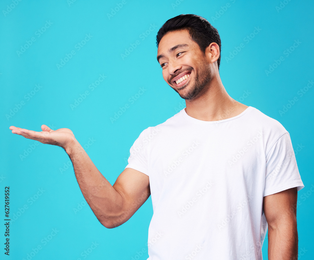 Mockup, showing and man with a smile, opportunity and decision against a blue studio background. Male person, advertising or model with promotion, hand gesture or presentation with thinking or choice Mockup, showing and man with a smile, opportunity and decision against a blue studio background. Male person, advertising or model with promotion, hand gesture or presentation with thinking or choice