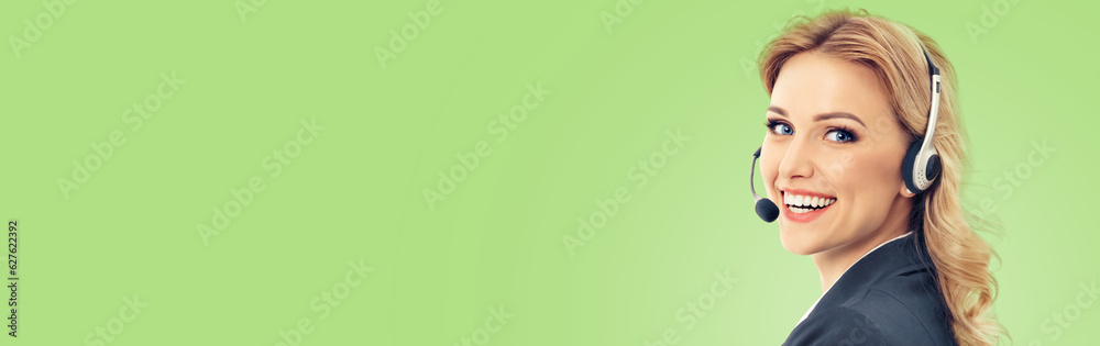 Call center. Smiling female support phone operator in headset, in grey confident suit, isolated over light green color background. Customer service help consulting. Copy space blank area for text.