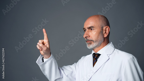 Middle-aged white man in a lab robe operating stereoscopic image.