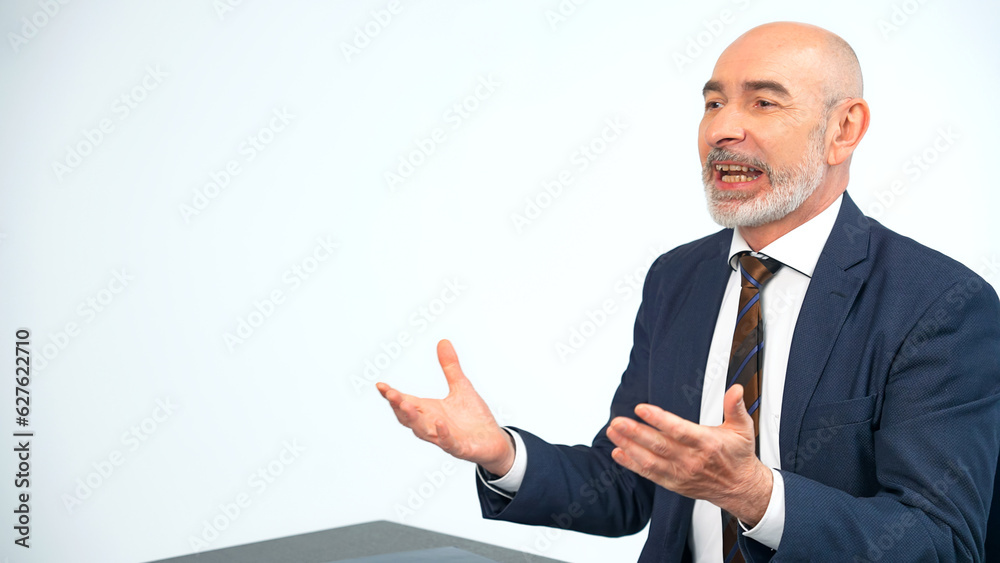 Middle-aged white man in a suit talking in the office. Job interview. Online meeting.