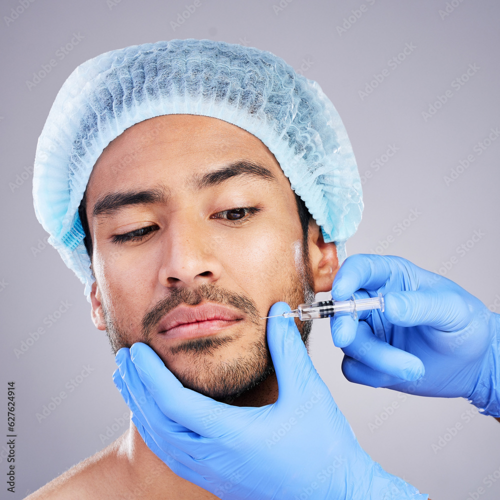 Hands, face and plastic surgery with a man in studio on a gray background for a botox injection. Needle, beauty and transformation with a male customer in a clinic for antiaging filler or cosmetics
