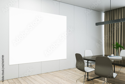 Blank white poster on a light wall in a modern meeting room with wooden office desk and chairs, mockup. 3D Rendering