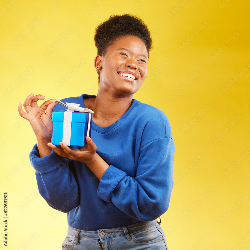 Gift, winning and happy black woman with a surprise isolated in a yellow studio background for a birthday. Giveaway, box and excited person to celebrate, party and holiday as a winner with happiness Gift, winning and happy black woman with a surprise isolated in a yellow studio background for a birthday. Giveaway, box and excited person to celebrate, party and holiday as a winner with happiness