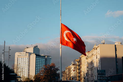 National Turkish flag waving against blue sky