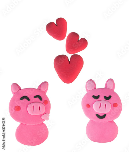 Set of Kissing pig made from plasticine on white © warapatr_s