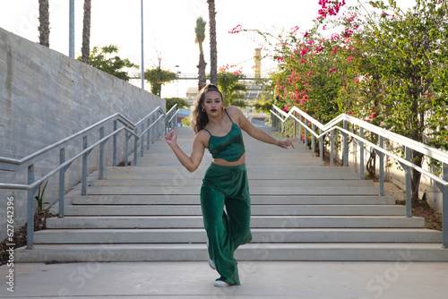 Canvastavla Latin and Hispanic girl, young and beautiful, dancing modern dance in the street outdoors