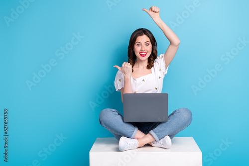 Full length photo of adorable excited lady wear white blouse typing gadget two thumbs empty space isolated blue color background © deagreez