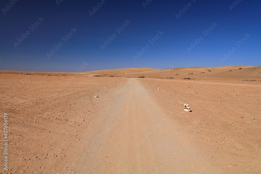 Agafay desert landscape near Marrakech, Morocco. Desert dirt road.
