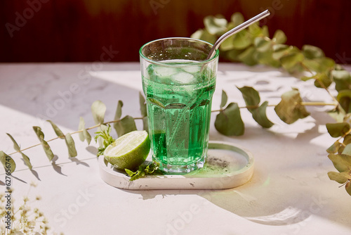 Aesthetic citrus healthy tarragon detox sparkling cocktail. Non alcoholic vitaminized healthy beverage. Green Mocktail for St. Patricks Day photo