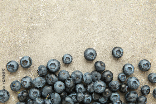 Colorful blueberries on grey concrete background. Top view. Flat lay
