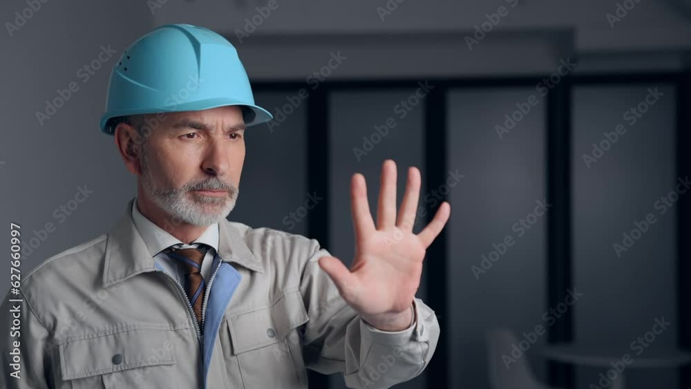 Middle-aged white engineer in a working wear touching stereoscopic image. Middle-aged white engineer in a working wear touching stereoscopic image.