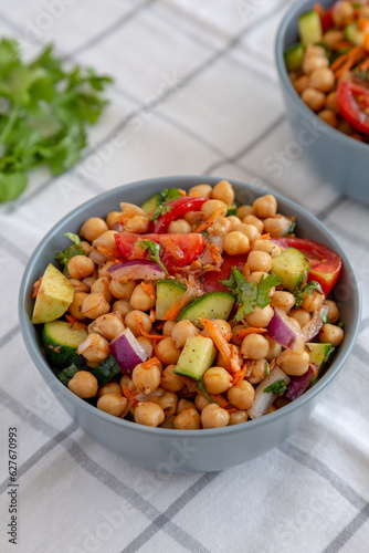 Homemade Avocado Chickpea Salad with Chili Lime Dressing in a Bowl, side view.