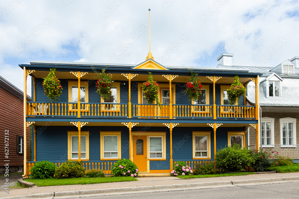 Early 20th Century two-family blue wooden house with ornate porches, Beauport area, Quebec City, Quebec, Canada Early 20th Century two-family blue wooden house with ornate porches, Beauport area, Quebec City, Quebec, Canada