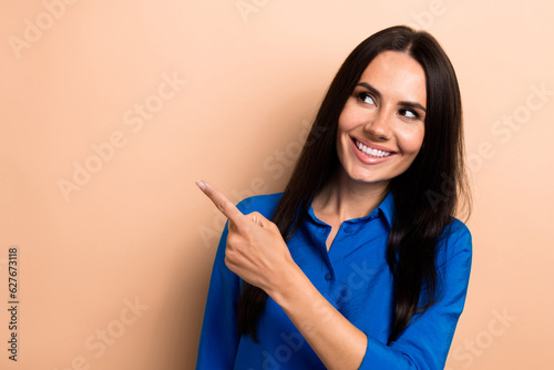 Photo of gorgeous stunning lady wear blue trendy clothes fingers direct empty space cool offer poster isolated on beige color background