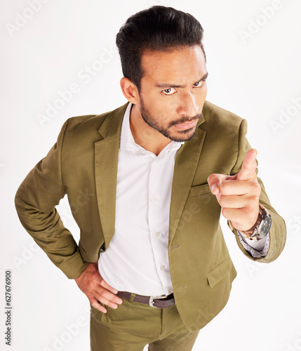 Portrait, blame and scolding with a business man in studio on a white background for discipline. Manager, finger wag and pointing with a serious young boss telling off an employee for control