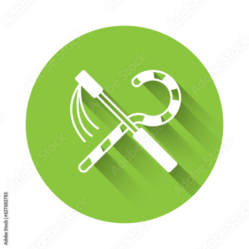 White Crook and flail icon isolated with long shadow background. Ancient Egypt symbol. Scepters of egypt. Green circle button. Vector