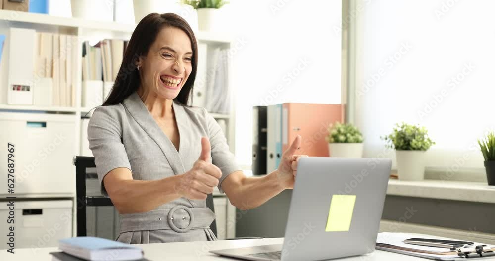 Business woman typing on laptop keyboard and enjoying positive news 4k movie. Successful business concept