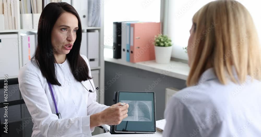 Doctor showing digital tablet to patient with CT scan of lungs 4k movie. Diagnostics and treatment of longterm consequences of covid 19 concept Doctor showing digital tablet to patient with CT scan of lungs 4k movie. Diagnostics and treatment of longterm consequences of covid 19 concept