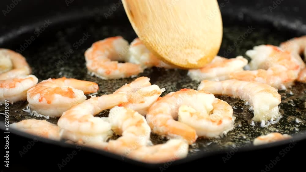 Frying fresh pink shrimps in pan Frying fresh pink shrimps in pan
