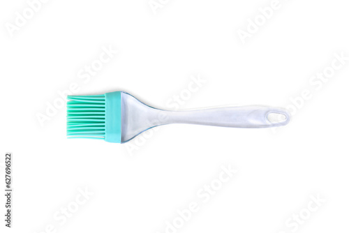Green silicone cooking brush on a white background.
