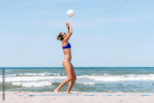 Professional player woman playing volleyball on the beach. Horizontal sport theme poster, greeting cards, headers, website and app