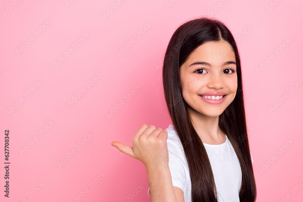 Photo portrait of cute schoolgirl finger point shopping discount promo dressed stylish white clothes isolated on pink color background Photo portrait of cute schoolgirl finger point shopping discount promo dressed stylish white clothes isolated on pink color background