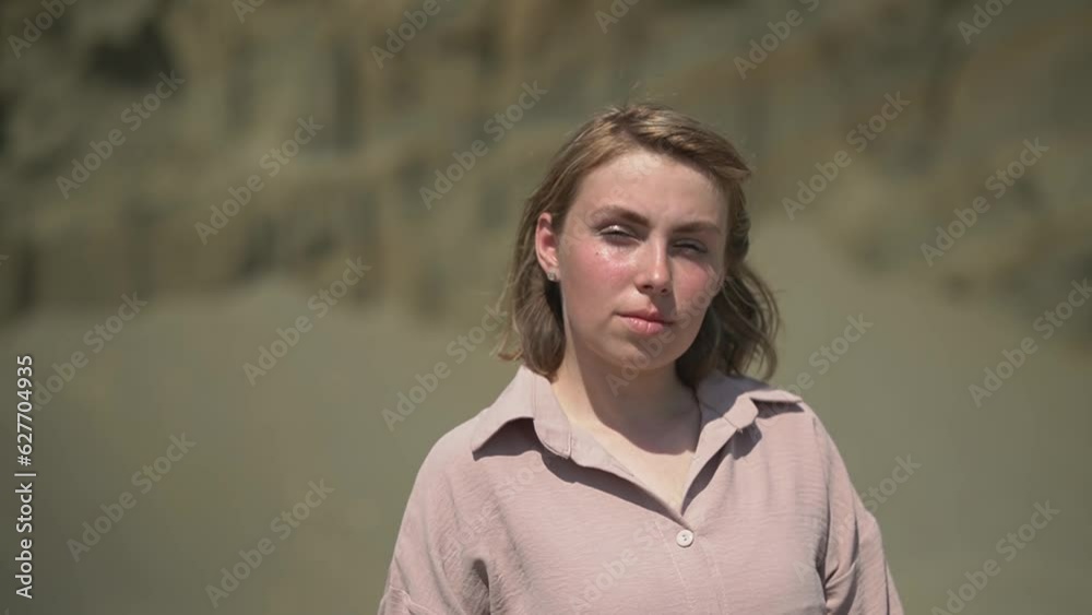 Caucasian woman looking at the camera. blonde woman in white casual clothes. slow motion video. High quality Full HD video recording