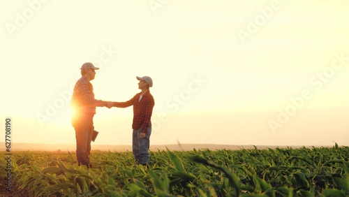 two farmers work tablet sunset, farming teamwork group people contract handshake agreement sunset corn wheat, two meeting engineer successful concept rural agricultural work handsome harvest focusing